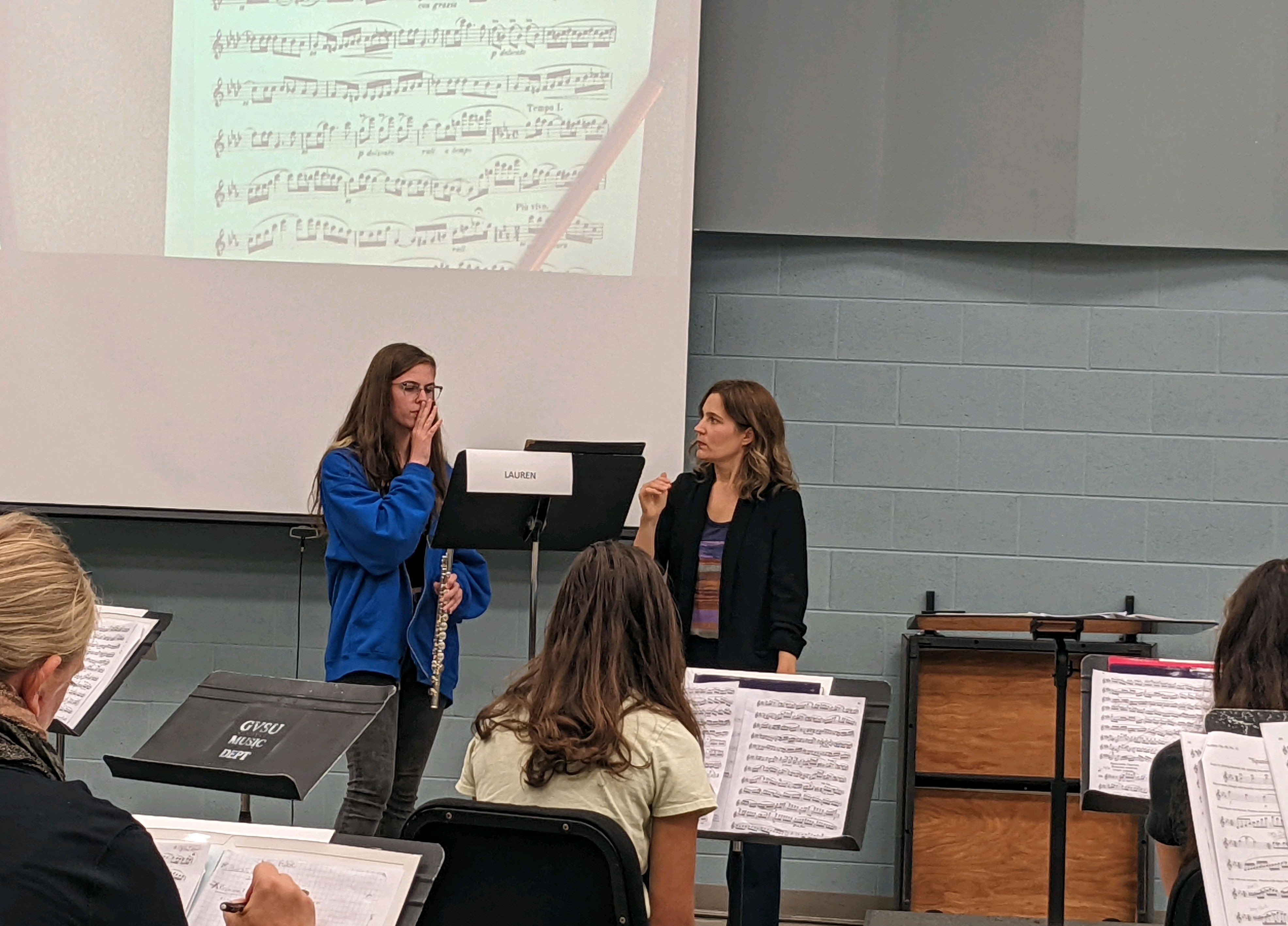 Abigail Walsh coaching a flute student during a collaborative group class.